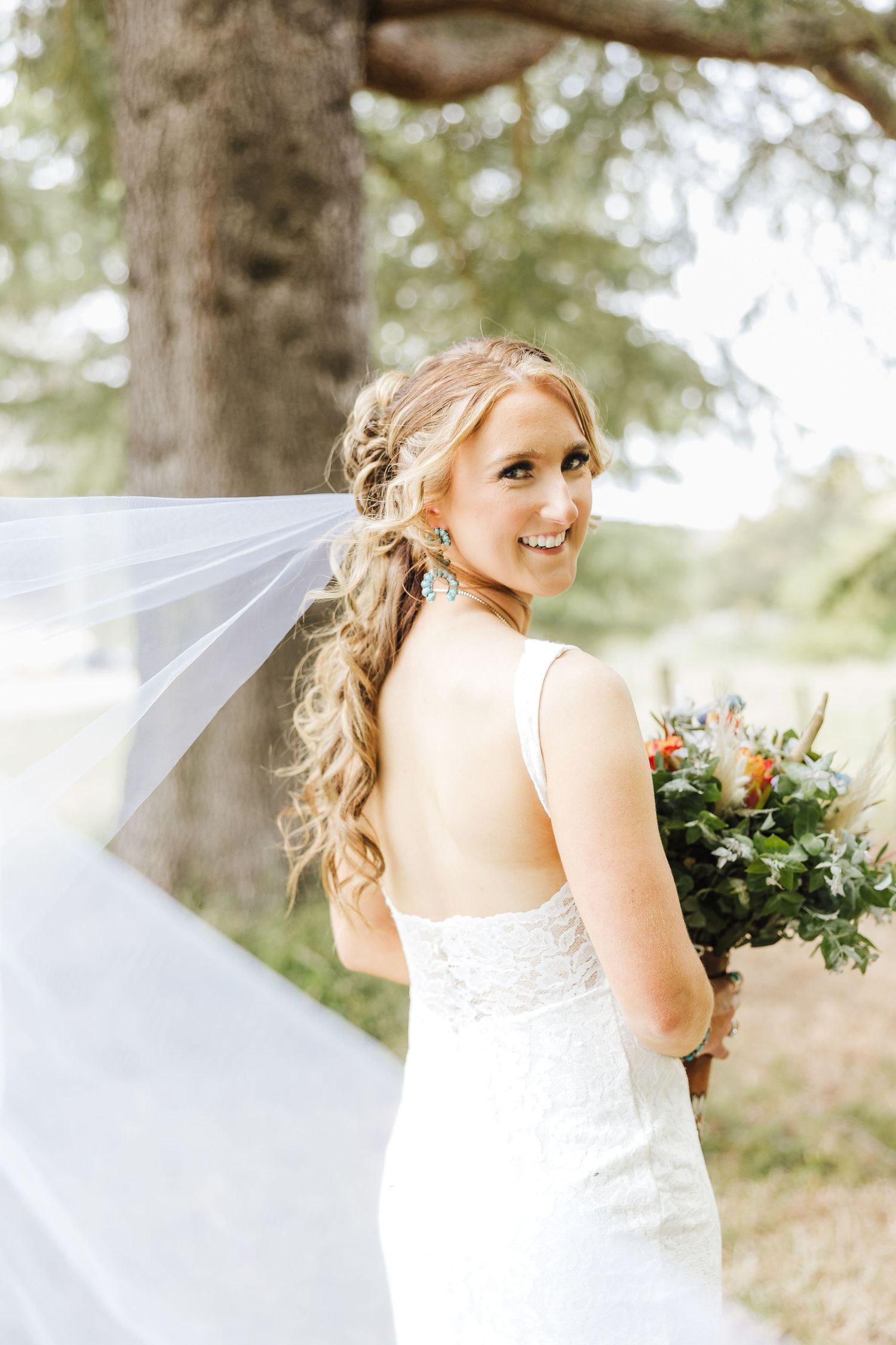 A bridal portrait series showing a person in a flowing white wedding dress with flowers and veil against a wooded backdrop.
