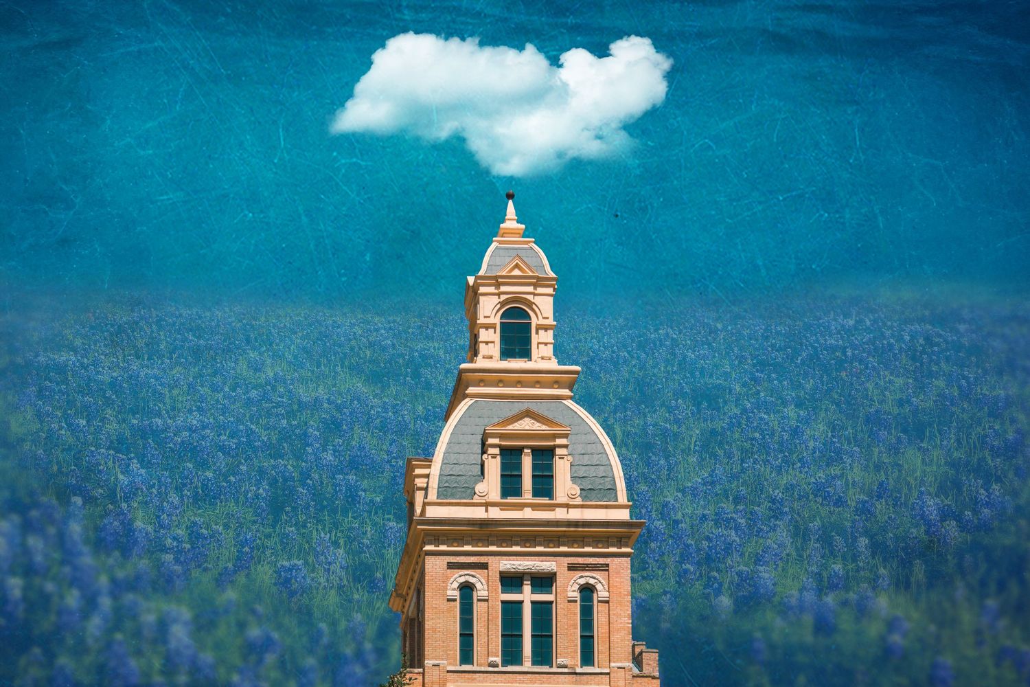 A panoramic view of church steeples and bell towers against a vibrant blue sky with forested mountains in the background.