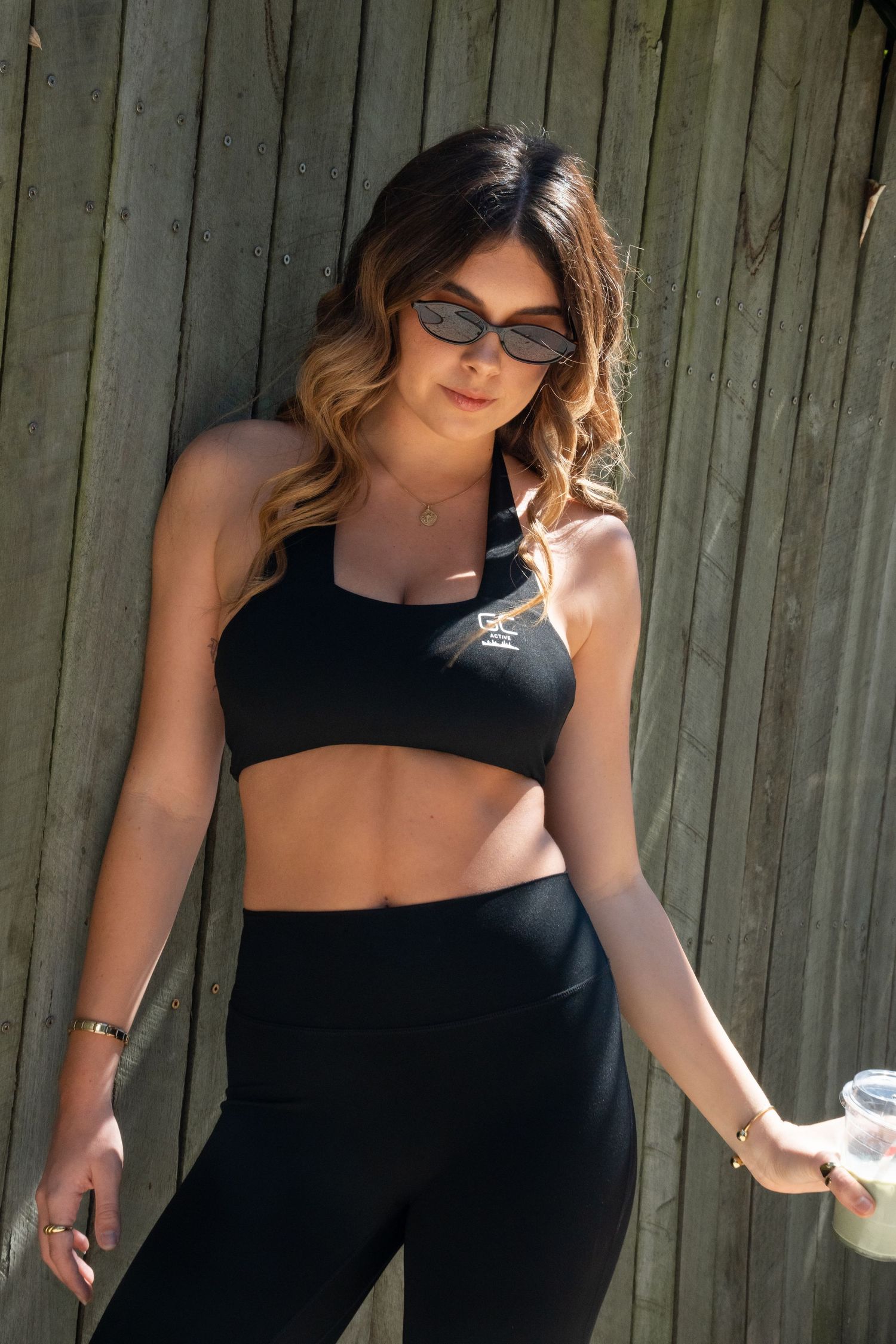 Model with coffee posing for activewear campaign shoot by experienced fashion photographer