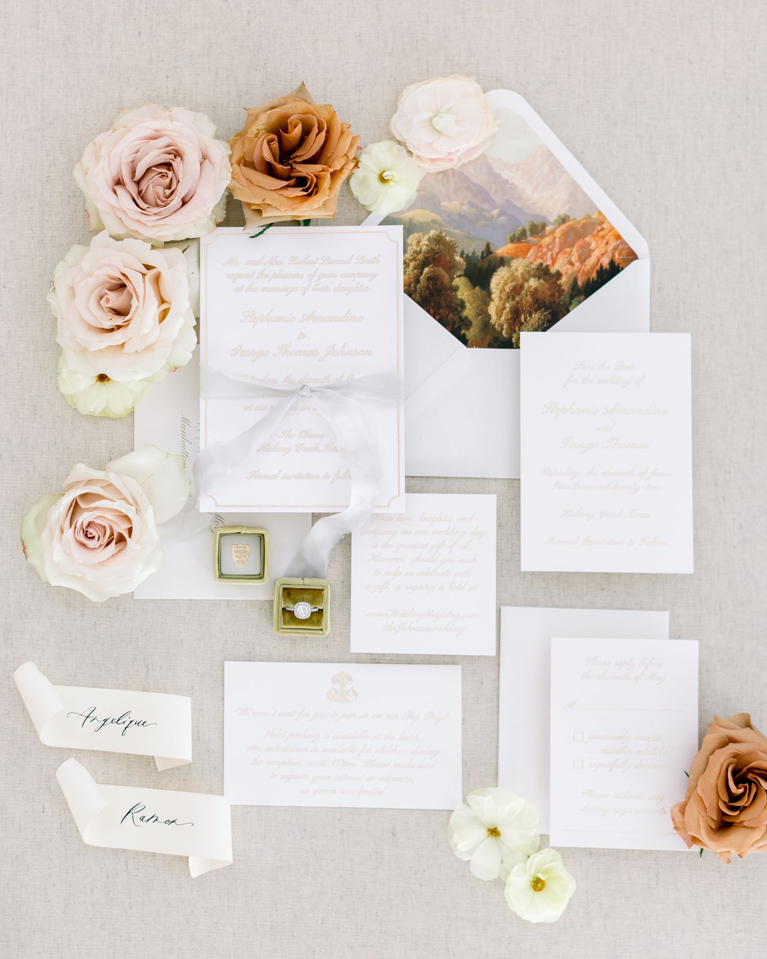 Elegant wedding stationery suite with blush pink roses and white paper pieces arranged on light gray background.