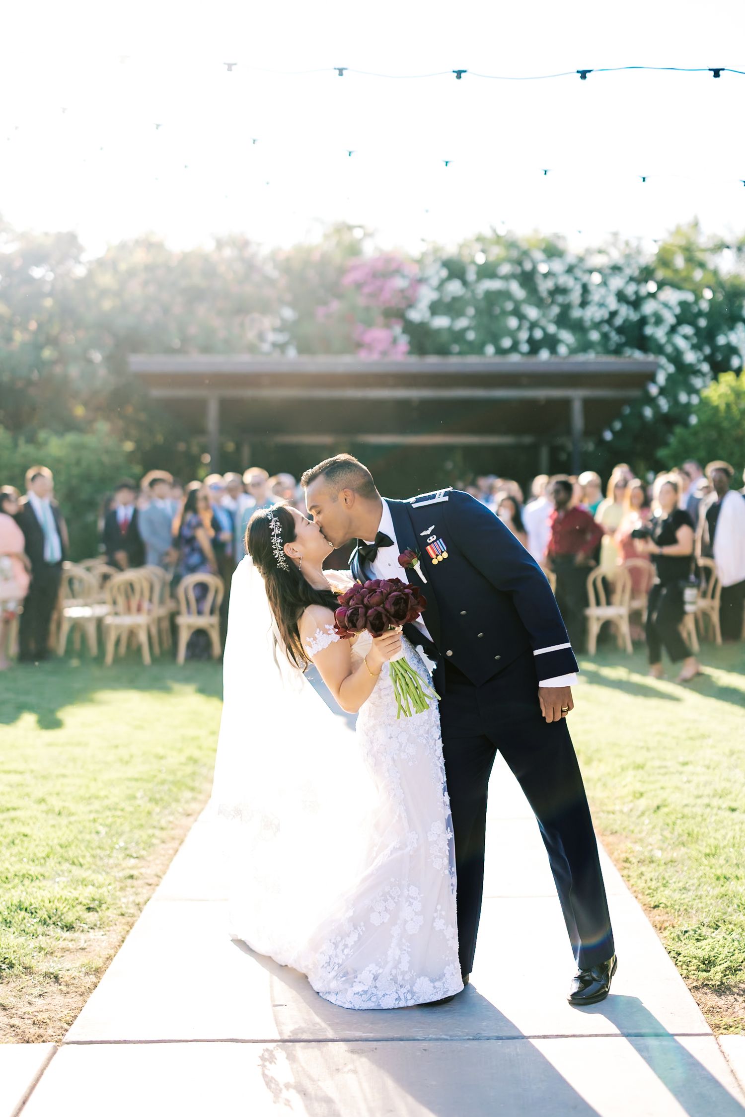A romantic outdoor wedding photoshoot sequence showing a couple in formal attire posing together at sunset.