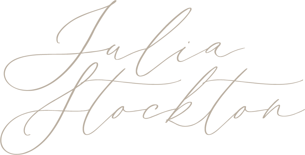 Elegant cursive signature logo of Julia Stockton in soft beige script on a white background.