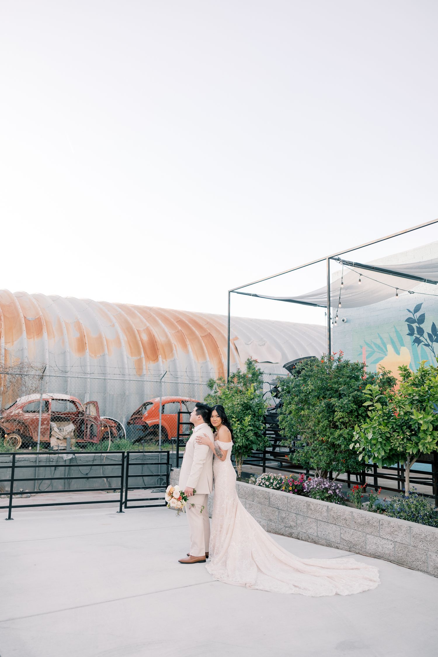 Romantic wedding photography session on a rooftop terrace with greenhouse domes and city views.