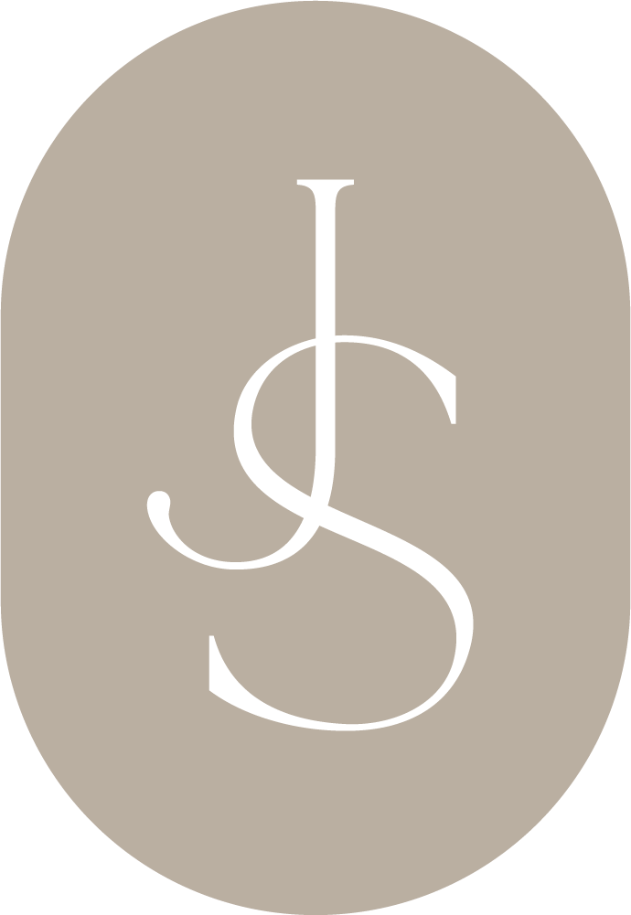 Elegant JS monogram logo in white on a taupe oval background, featuring intertwined cursive letters J and S.