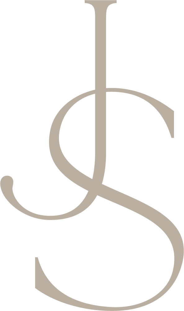 Elegant JS monogram logo in taupe, featuring intertwined cursive letters J and S in a sophisticated serif style.