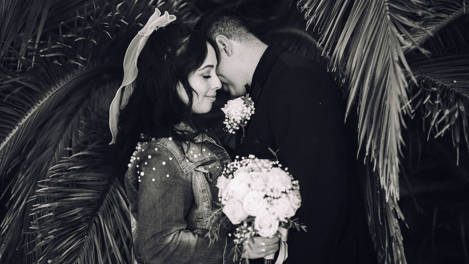 A collection of romantic black and white wedding photos showing couples embracing and dancing at their celebration.