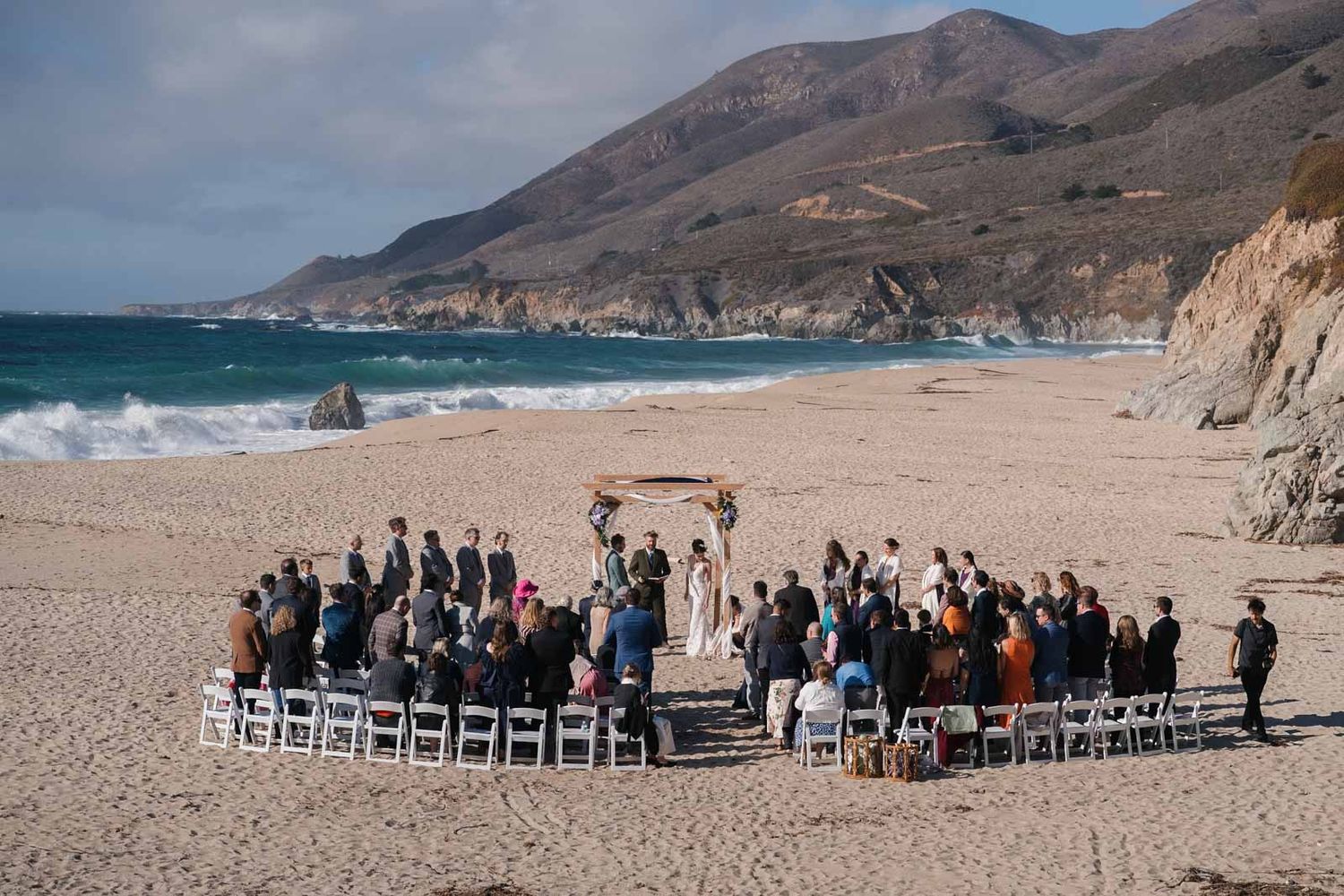 A panoramic sequence of a garrapata beach wedding ceremony setup with white chairs facing the ocean against dramatic coastal cliffs.