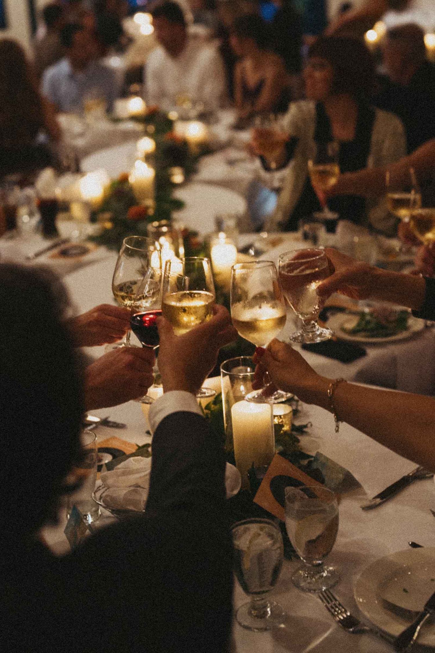 A candlelit dinner table setting with wine glasses and place settings creates an intimate dining atmosphere.