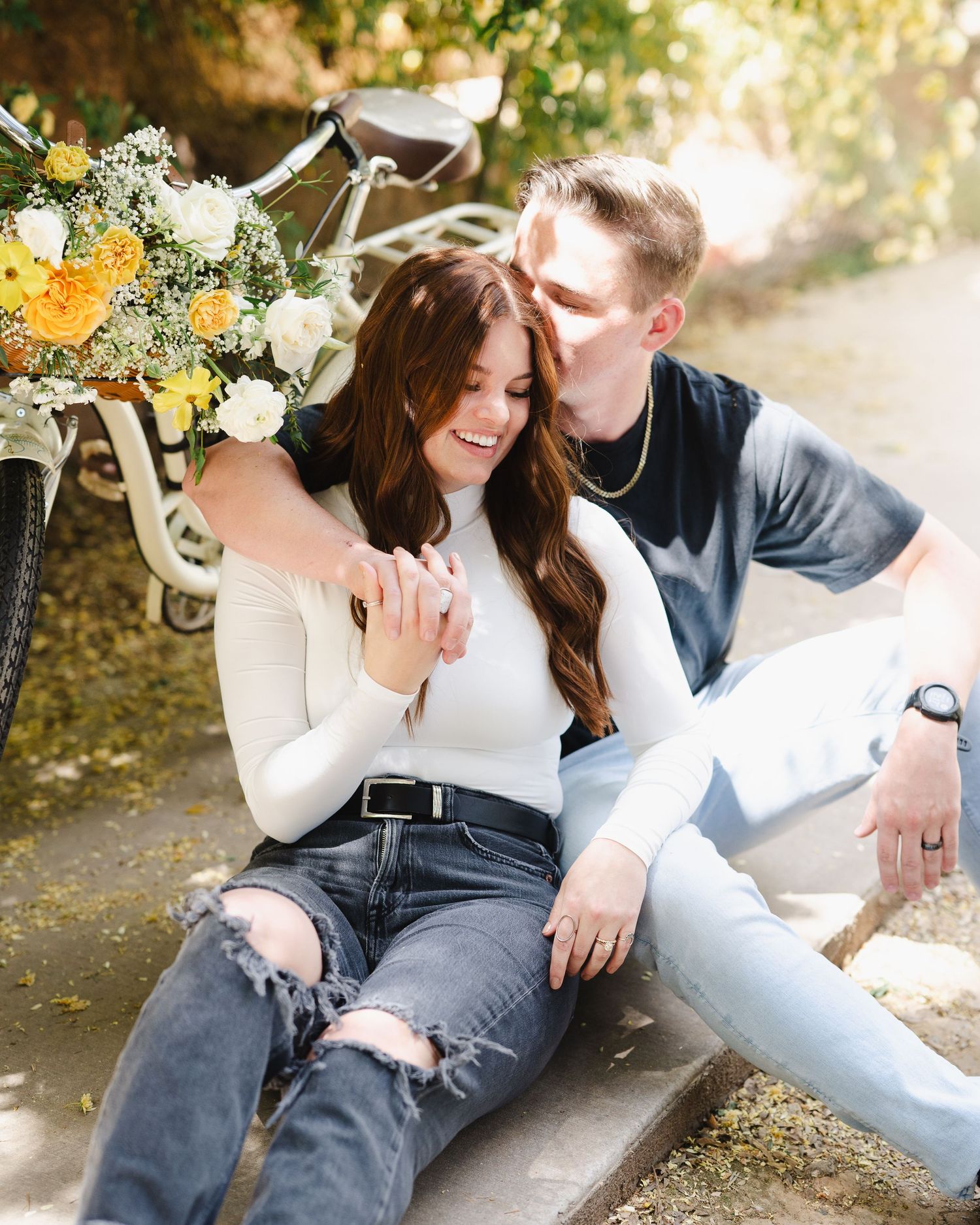 A joyful moment shared outdoors with yellow and white flowers in a vintage bicycle basket.