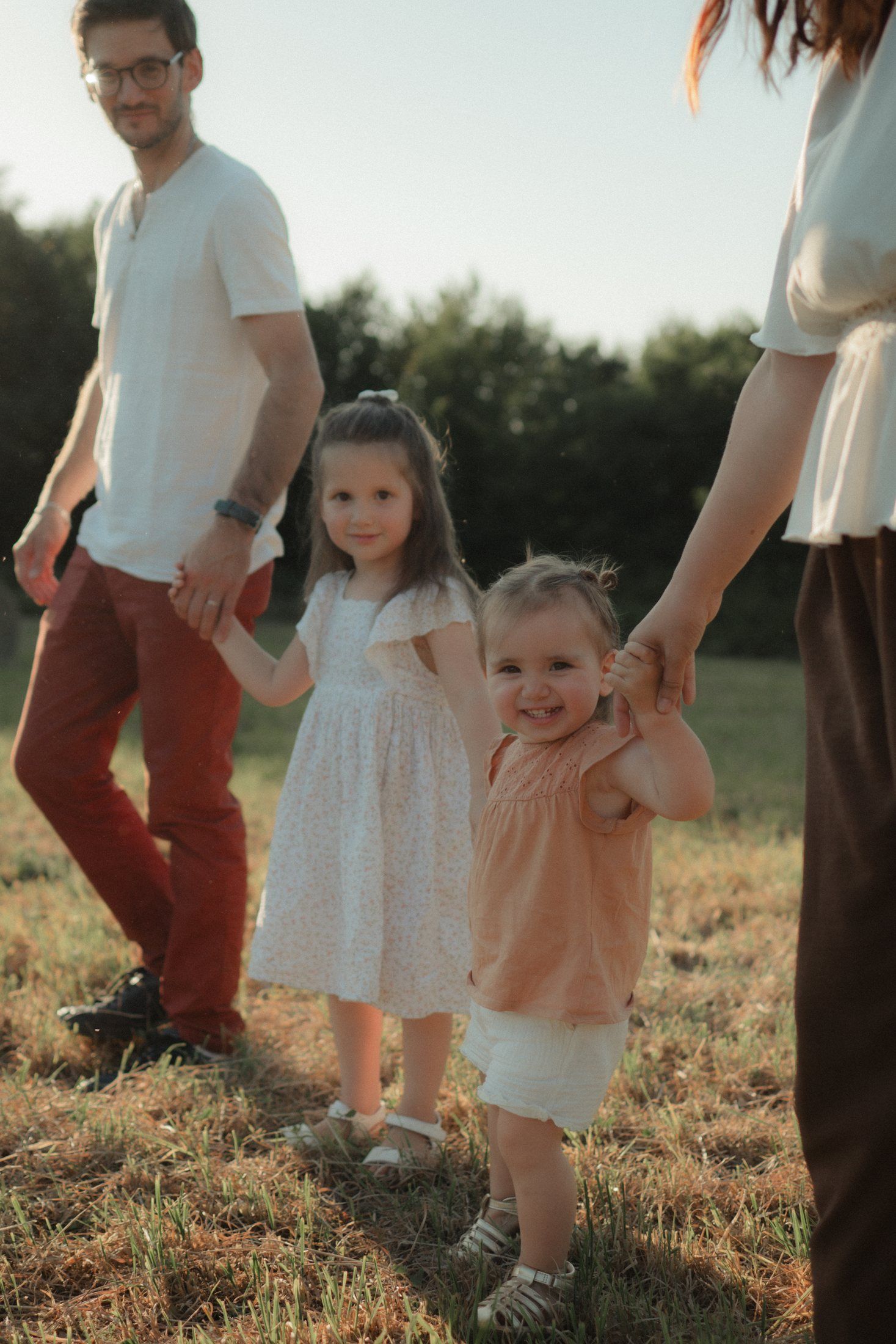 Parents marchant dans un champ avec leurs deux enfants
