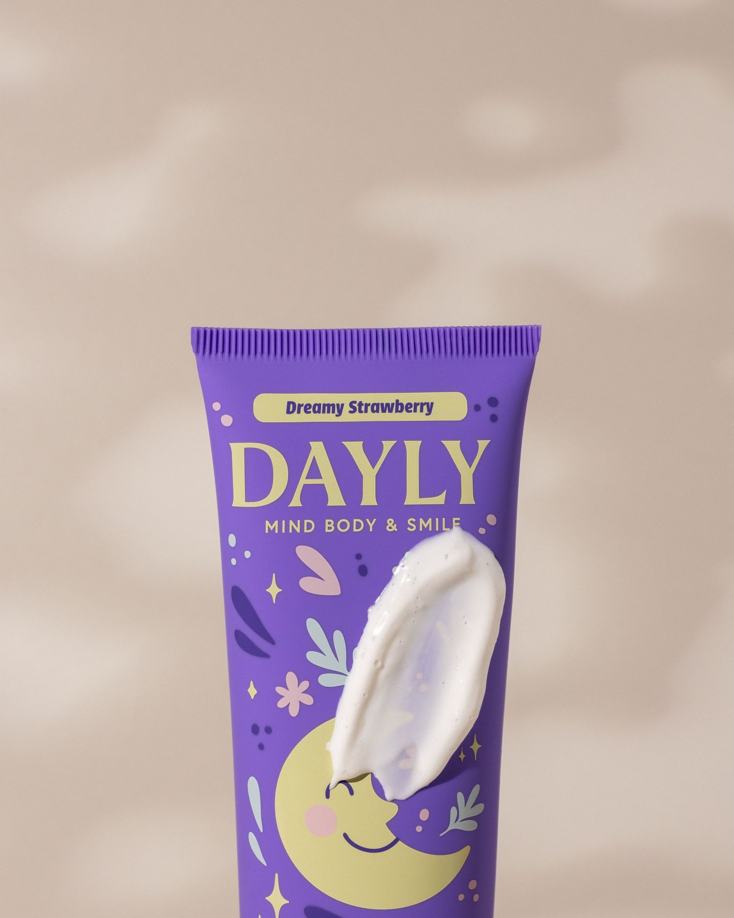 Dayly Mind Body & Smile Dreamy Strawberry scented lotion tube in purple with a smiling moon design.