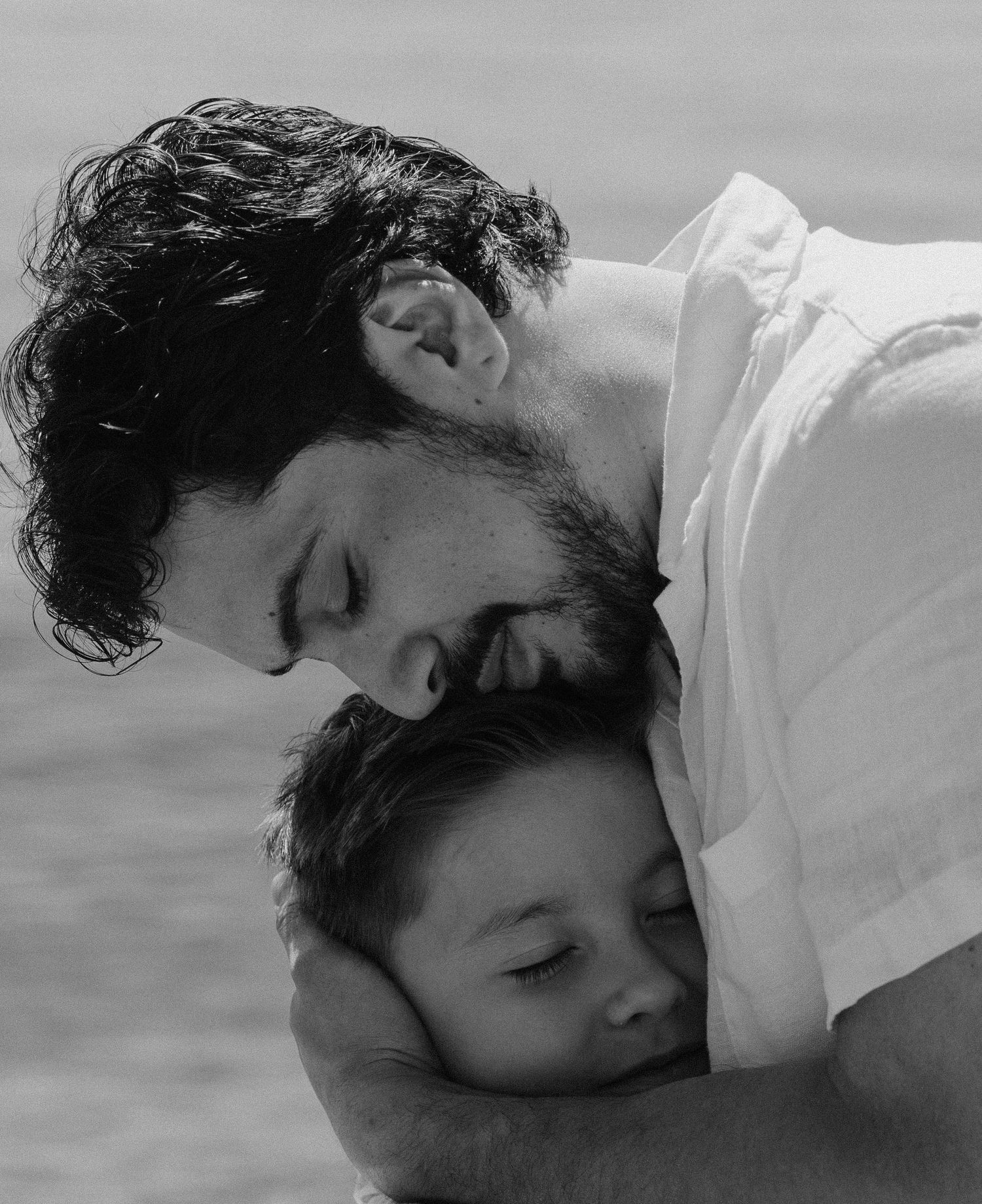 black and white photo of a dad hugging his son