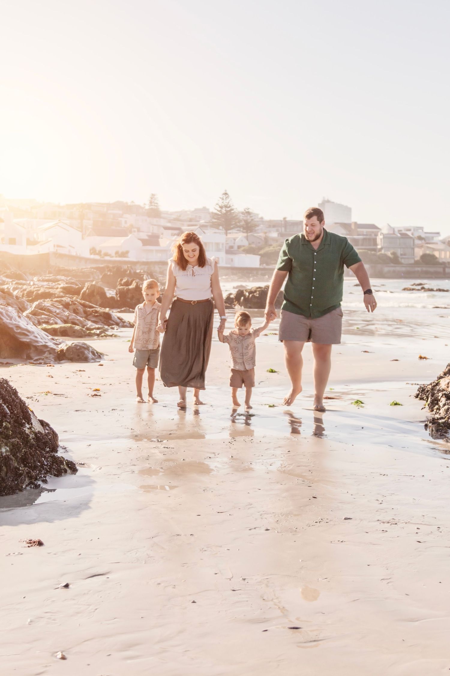 Candid family lifestyle photography session on Camps Bay beach at golden hour in Cape Town
