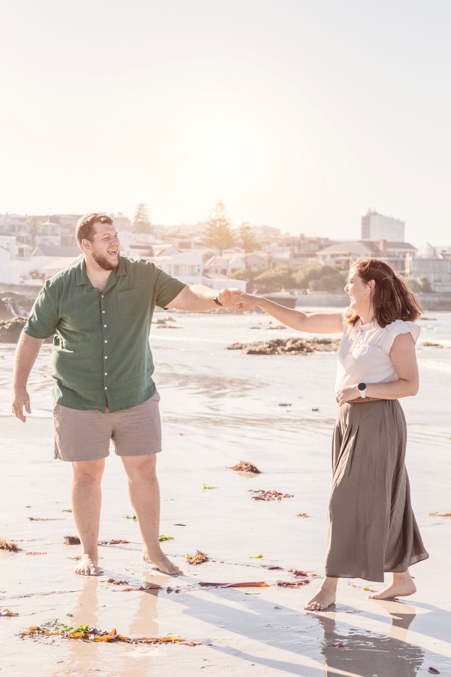 Candid family lifestyle photography session on Camps Bay beach at golden hour in Cape Town