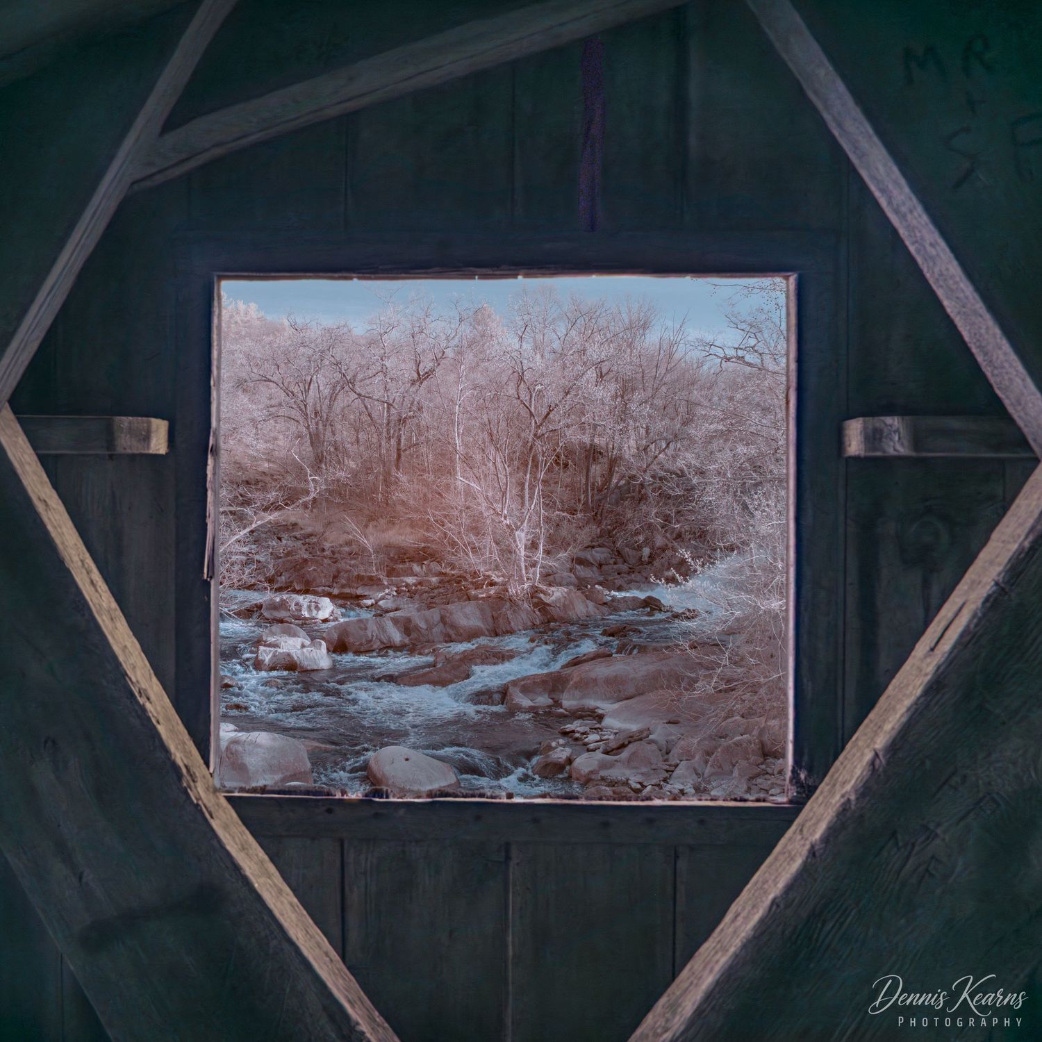 View of the of Housatonic river through a wooden covered bridge shot in infrared (false color)