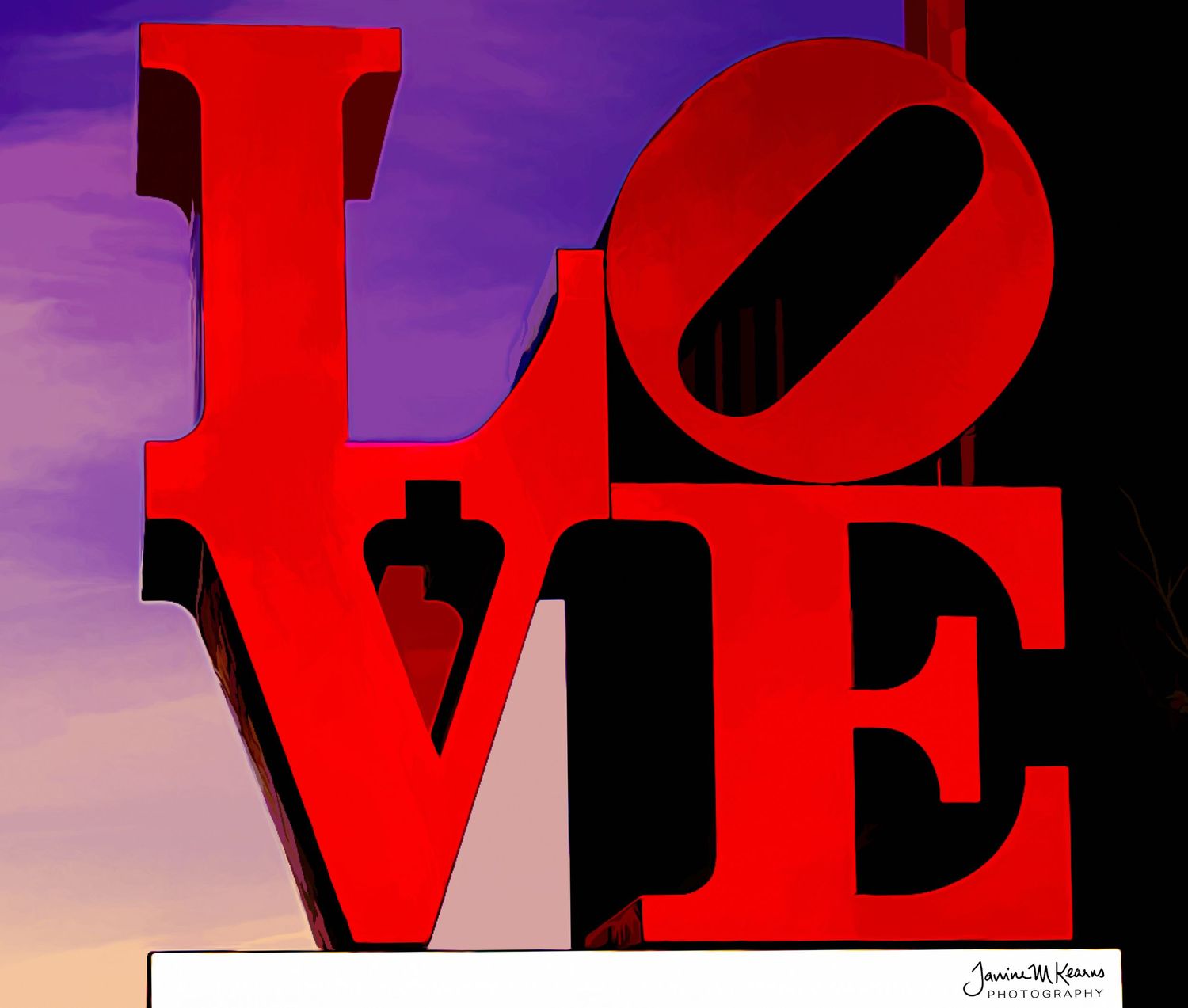 Red LOVE sculpture by Robert Indiana against a vibrant purple and orange sunset sky. Philadelphia, Pennsylvania