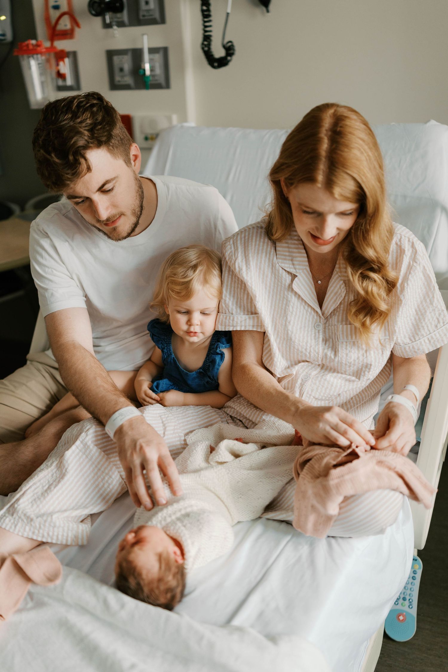 Fresh 48 session with family of three with a toddler meets their newborn baby in a hospital room in St. Louis, Missouri.