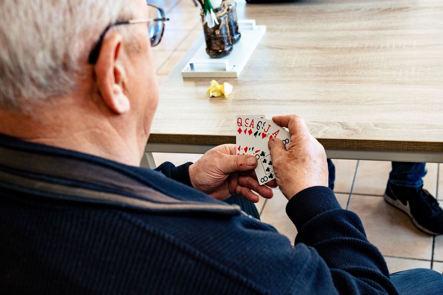Close-up shots of someone reading at a wooden table.