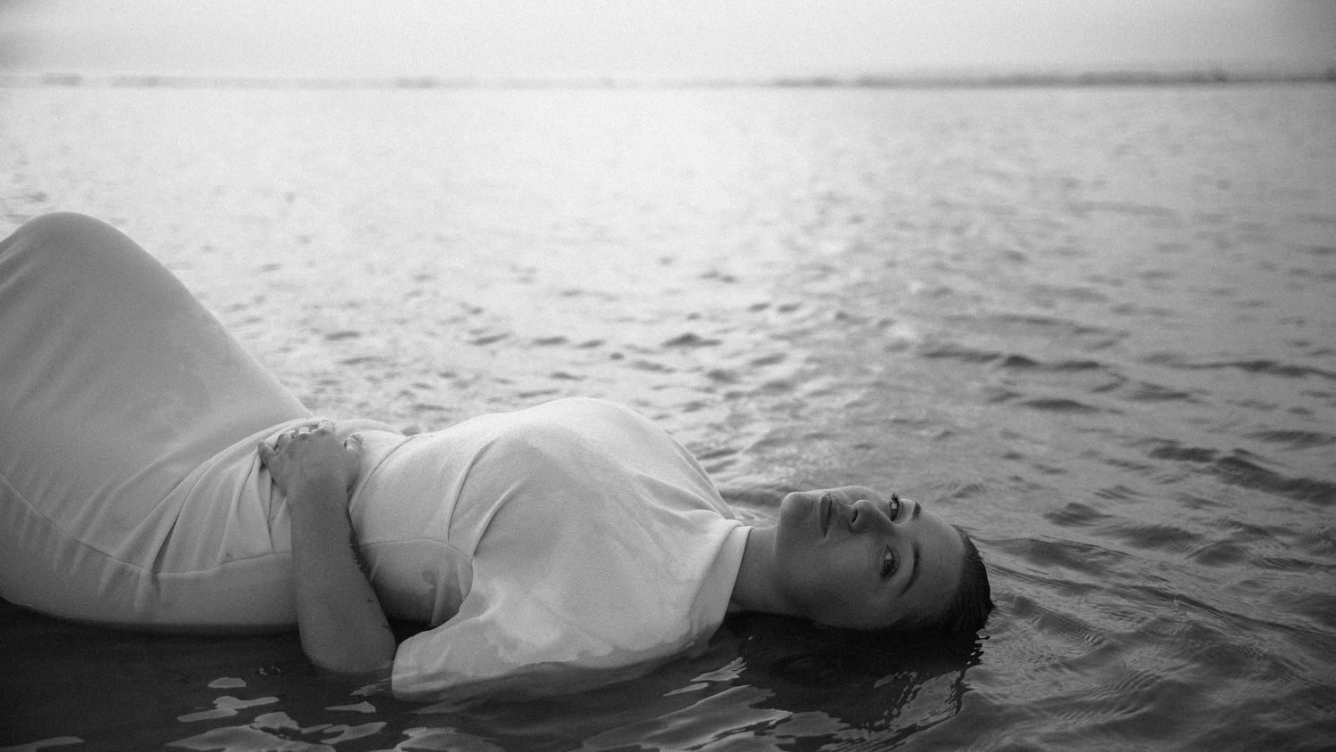 Pregnant woman in white dress floating in water - Sacred Water Ceremony fine art photography by Soft Sacred Studios