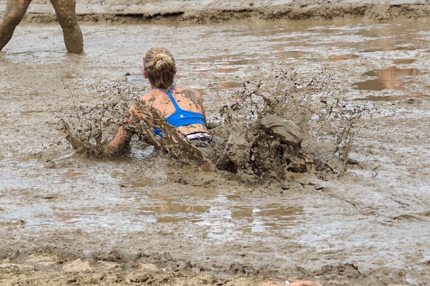 woman splashes in mud