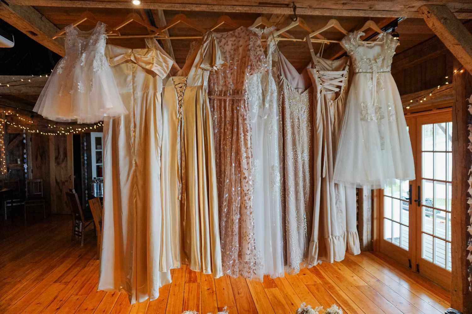 wedding party dresses hanging from beam
