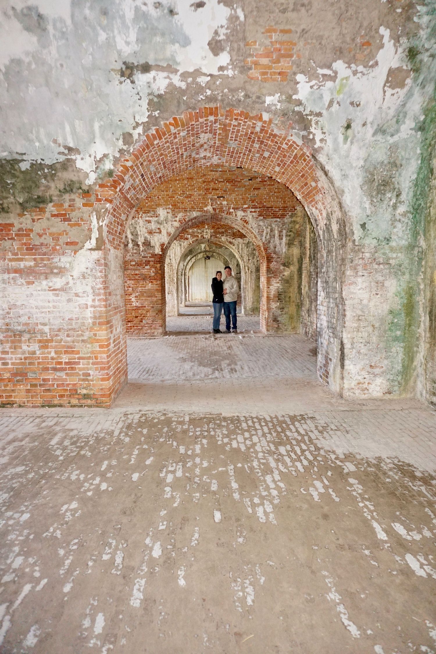 couple embracing in a brick tunnel