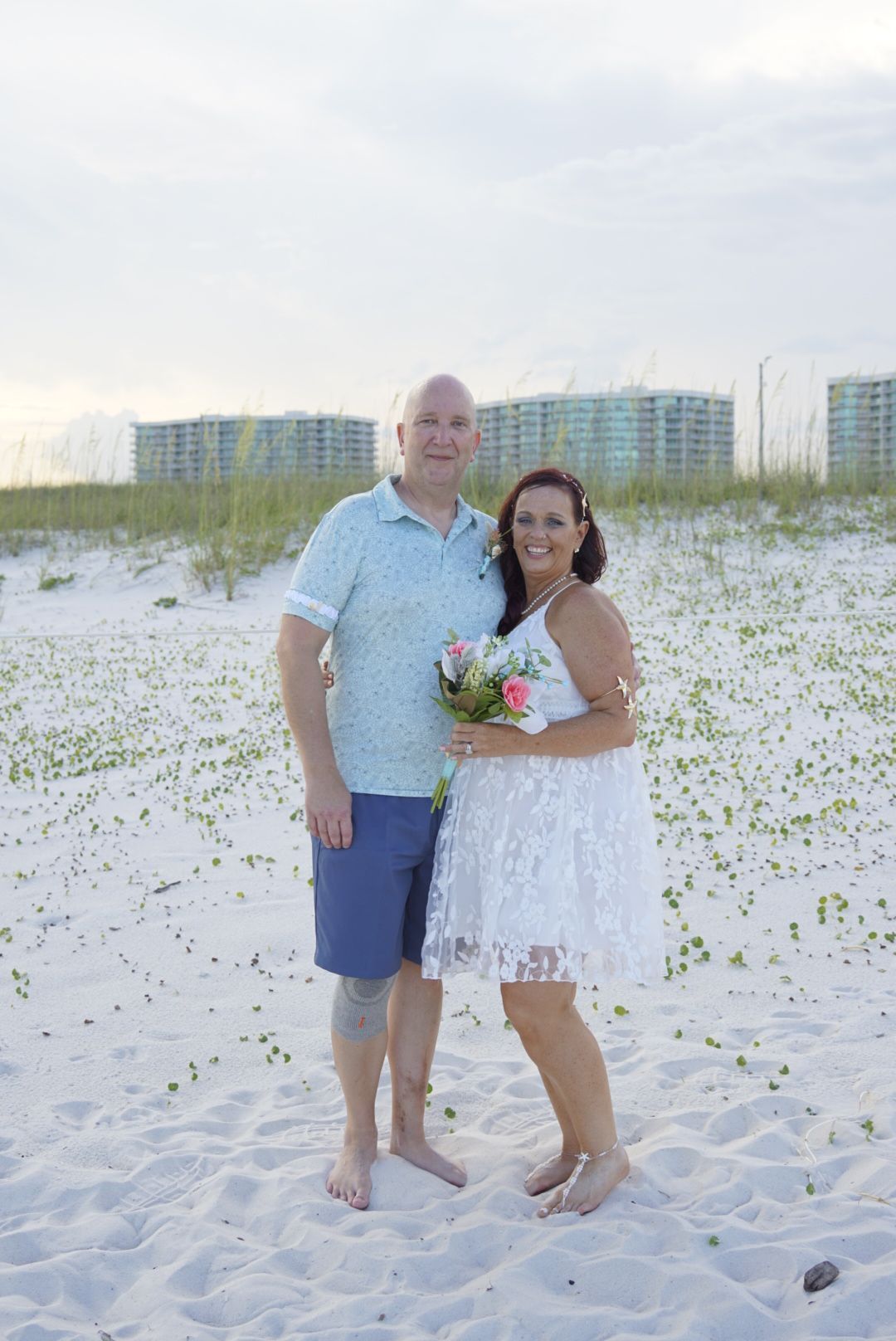 couple standing in front of the dunes