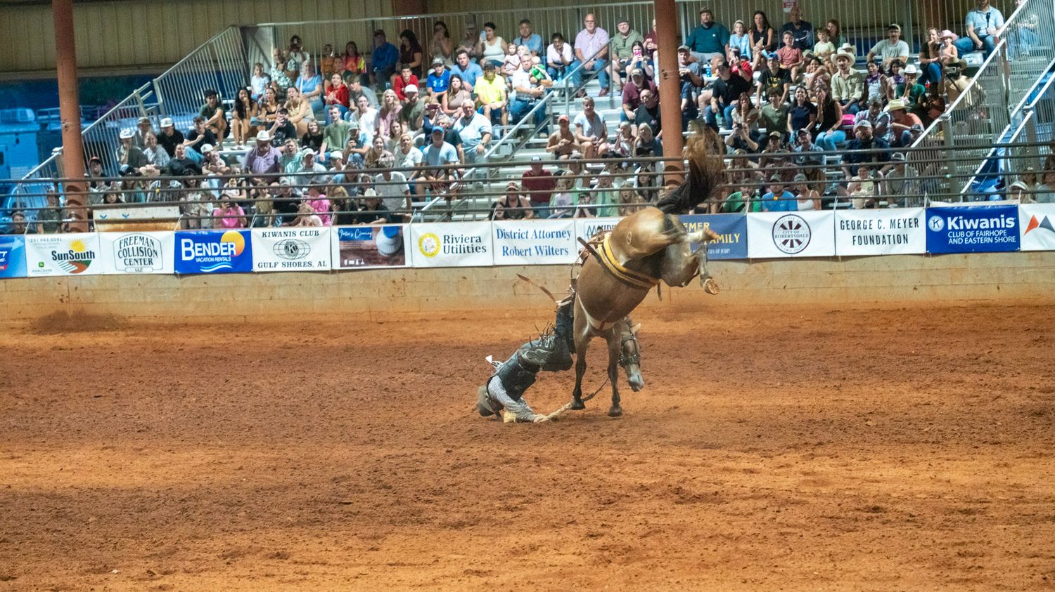 cowboy falling off of bronc