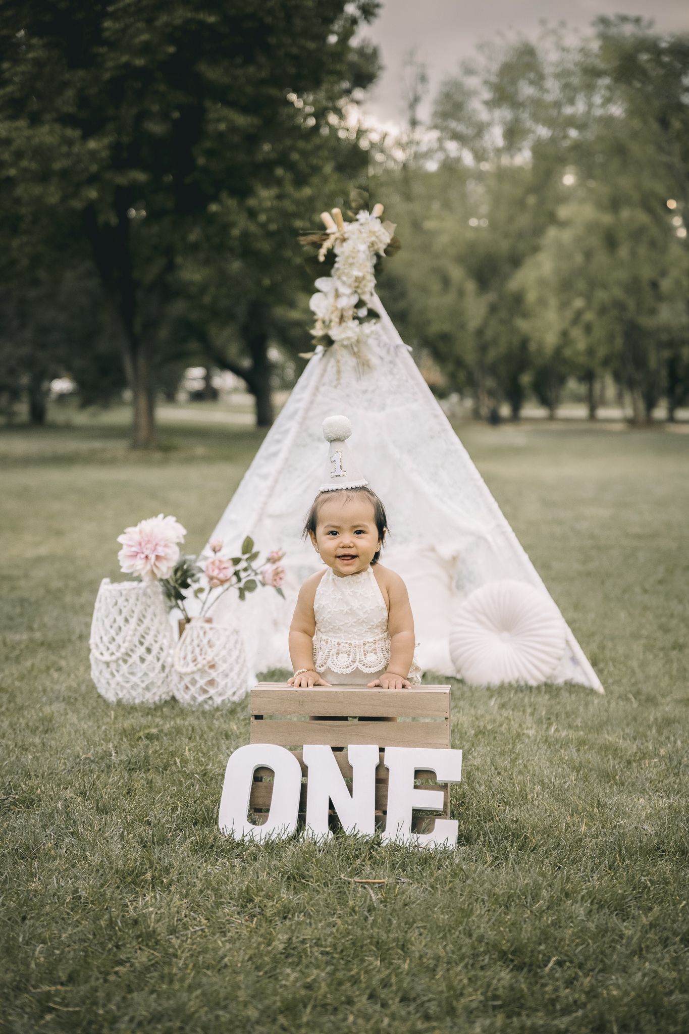 girl posing for his 1st birthday cake smash photoshoot during fall time
