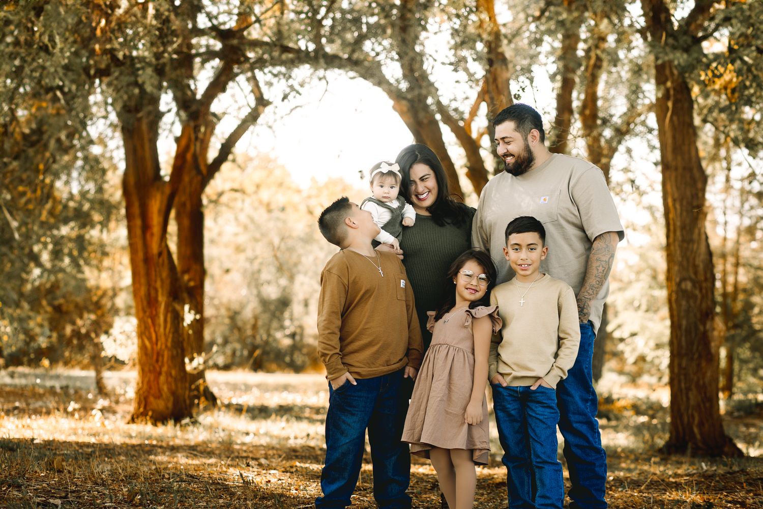 Fall family pictures taken in Northern Colorado. by Liz Rivas happy family in a candid poses for fall family photographs