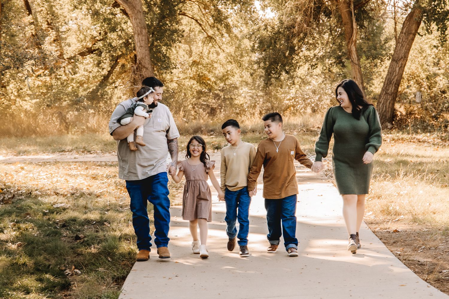 Fall family pictures taken in Northern Colorado. by Liz Rivas happy family in a candid poses for fall family photographs
