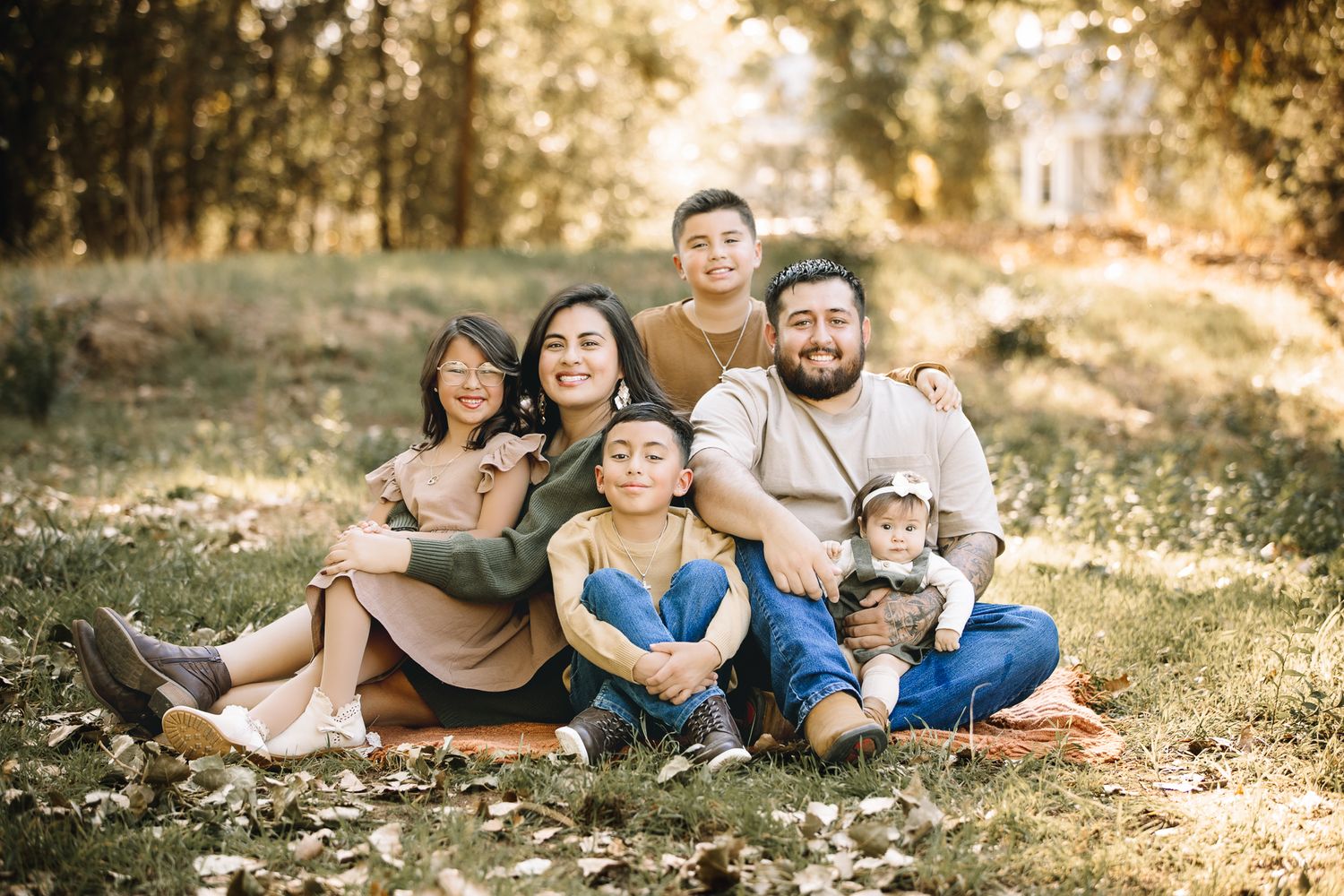 Fall family pictures taken in Northern Colorado. by Liz Rivas happy family in a candid poses for fall family photographs
