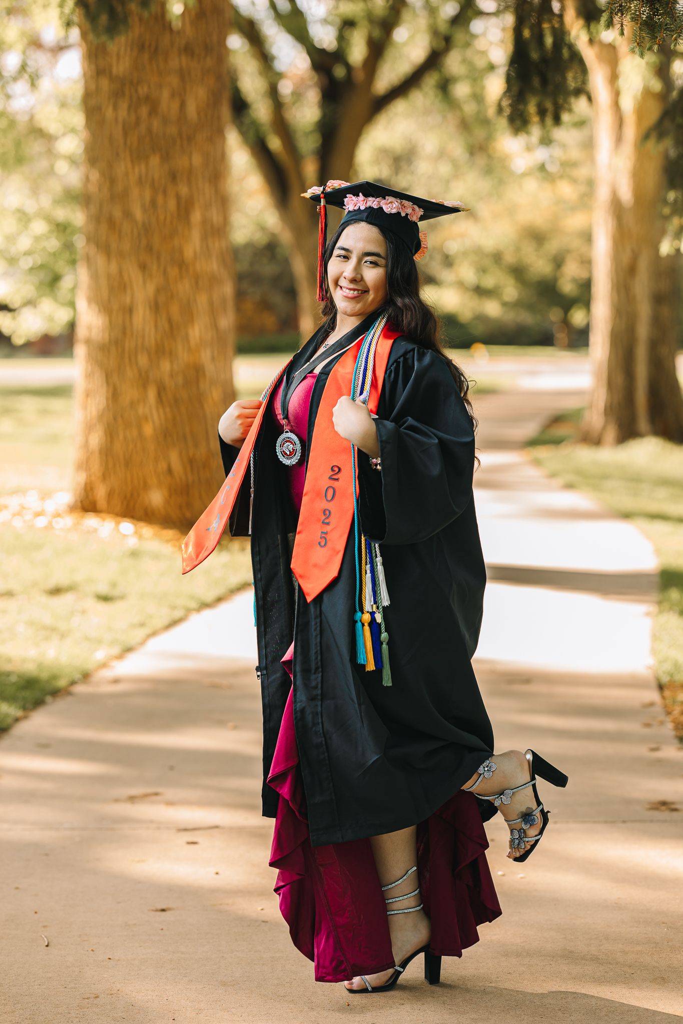 class of 2026 high school senior in Greeley Colorado posing for her senior pictures in her gown softly smiling at the photographer