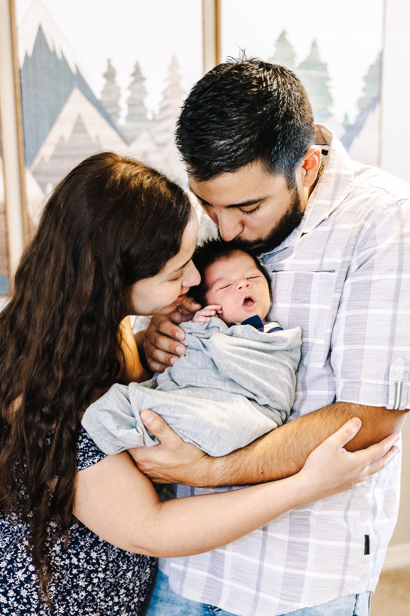 Newborn lifestyle photoshoot of a family located in Severance Colorado/ family posing with newborn baby inside their home taken by liz Rivas