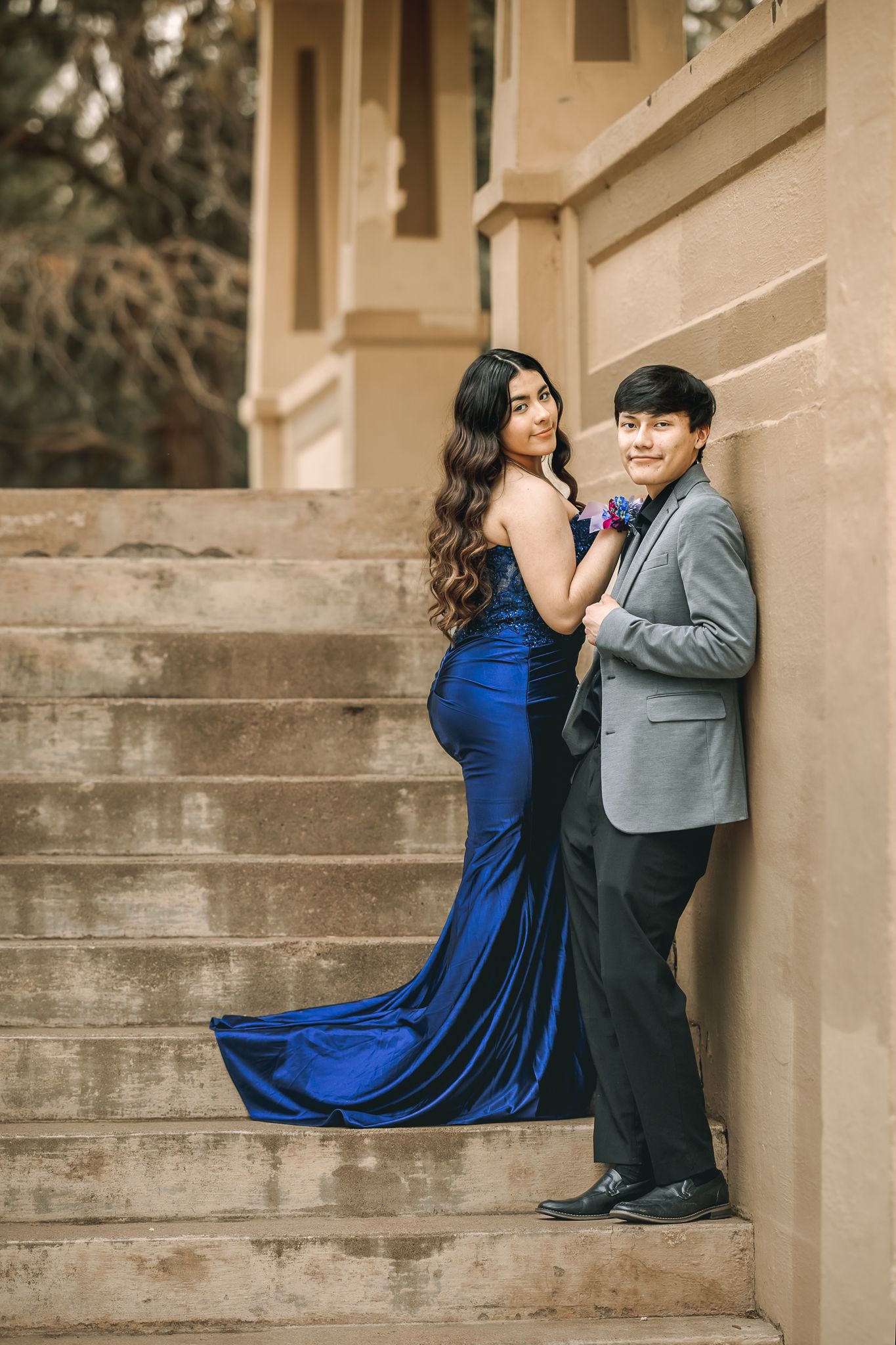 class of 2026 high school senior in Greeley Colorado posing for her senior prom pictures with her date softly smiling at the photographer