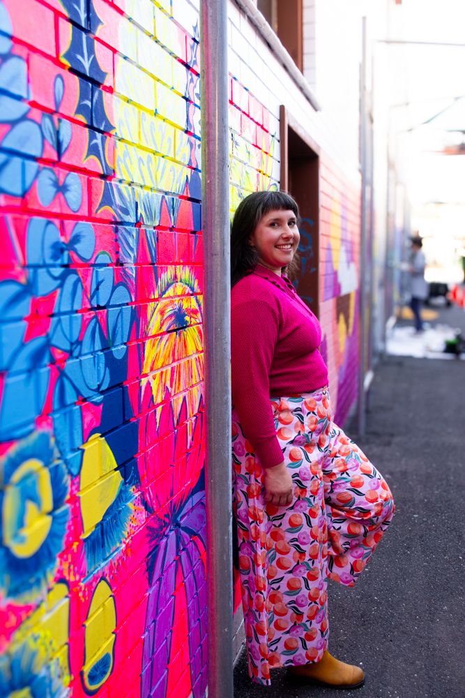 Kate from KateSmithsArt in front of her mural in Bendigo's Penny Weight Walk.