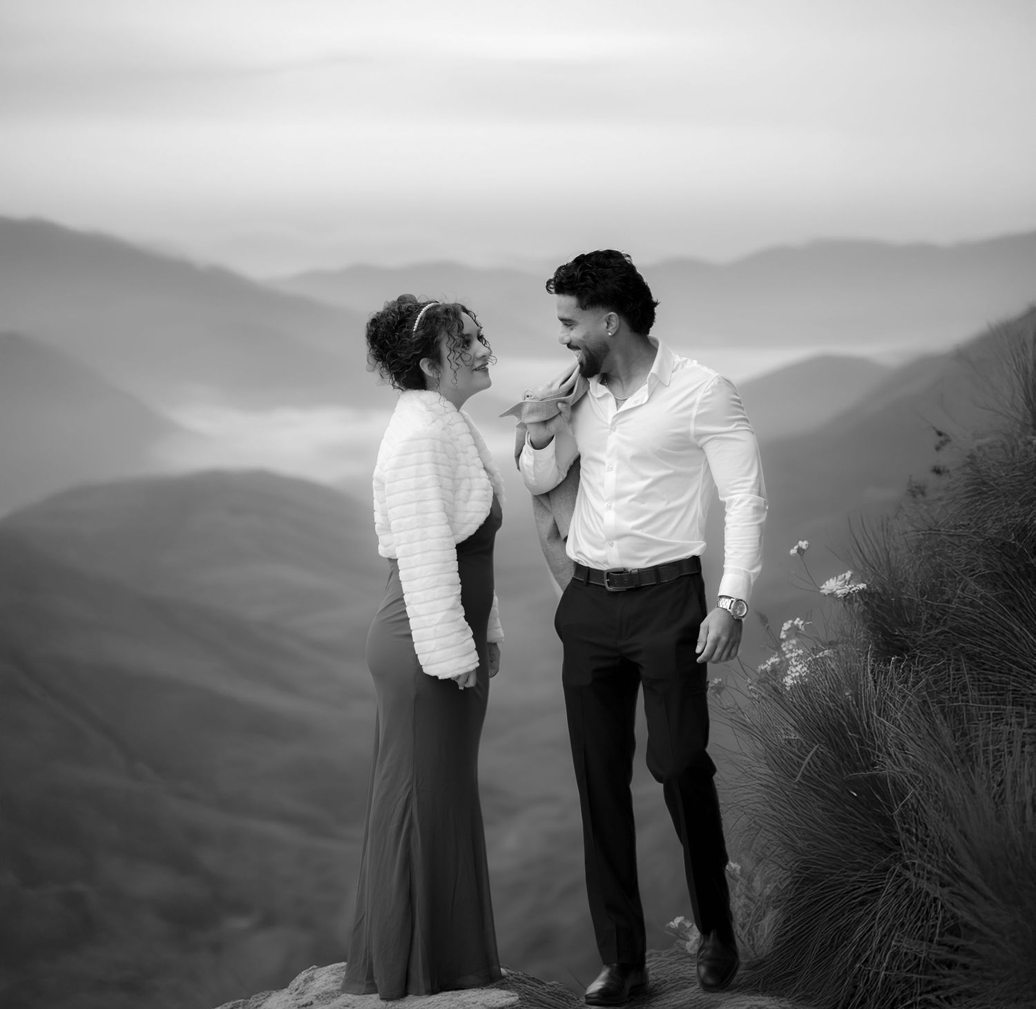 Romantic black and white engagement portrait of couple in mountain landscape photographed by Ionframe Studio