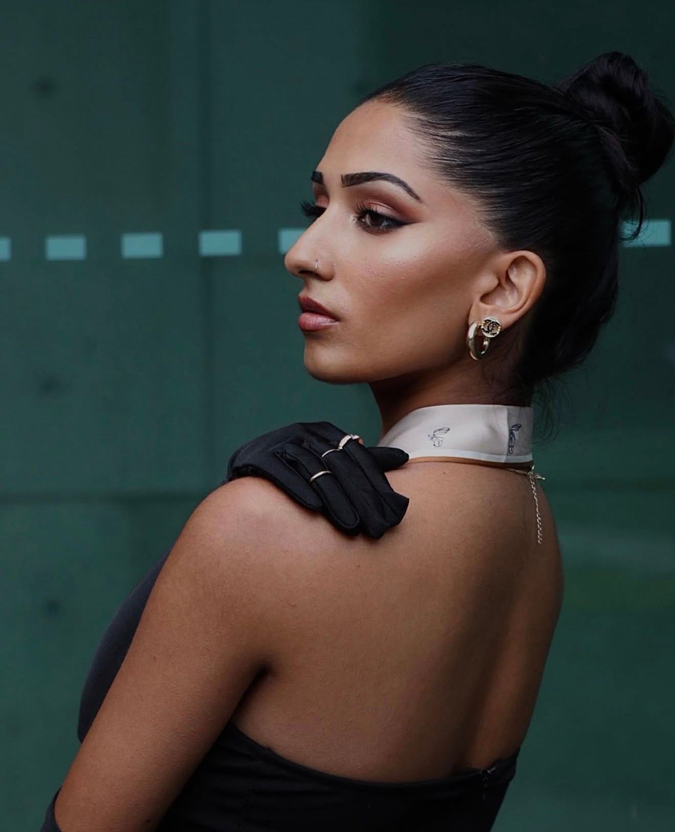 Elegant portrait series featuring glamorous makeup and jewelry against dark background.