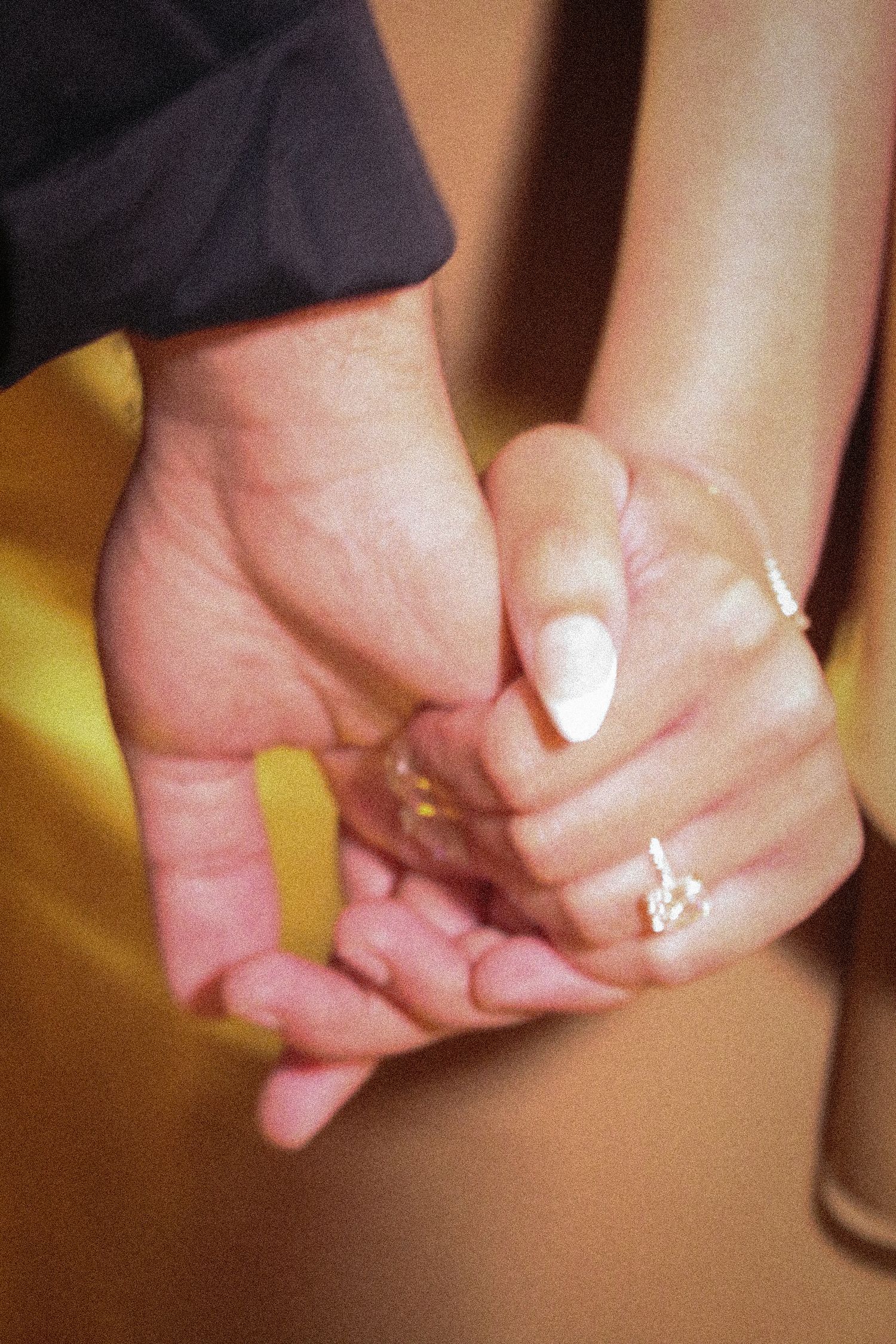 Series of hands clasped together in a row showing intimate connection and togetherness.