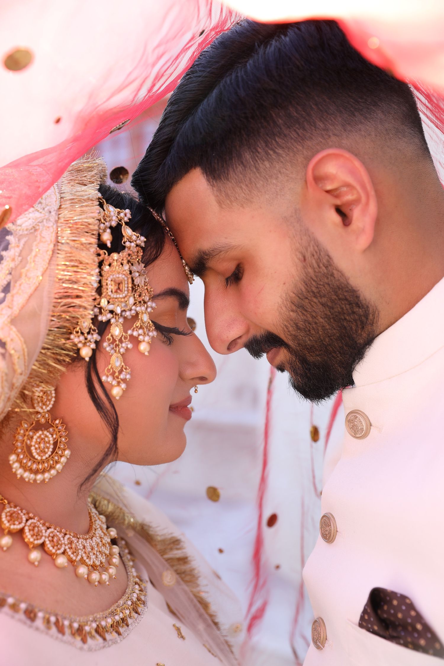 A romantic close-up collage of a couple in traditional Indian wedding attire and jewelry sharing intimate moments.