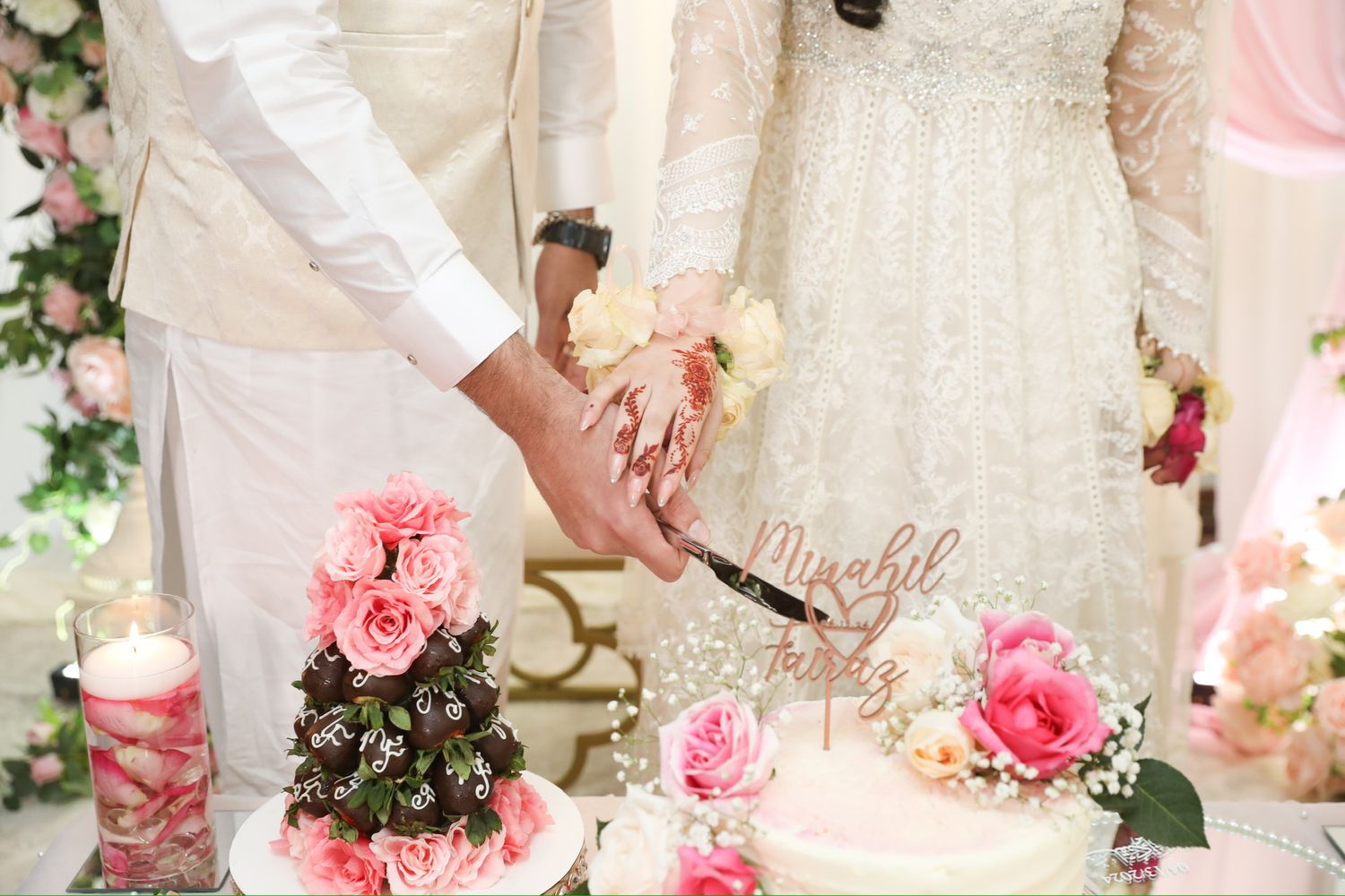 Elegant wedding decor with pink roses and white drapery creating a romantic atmosphere.