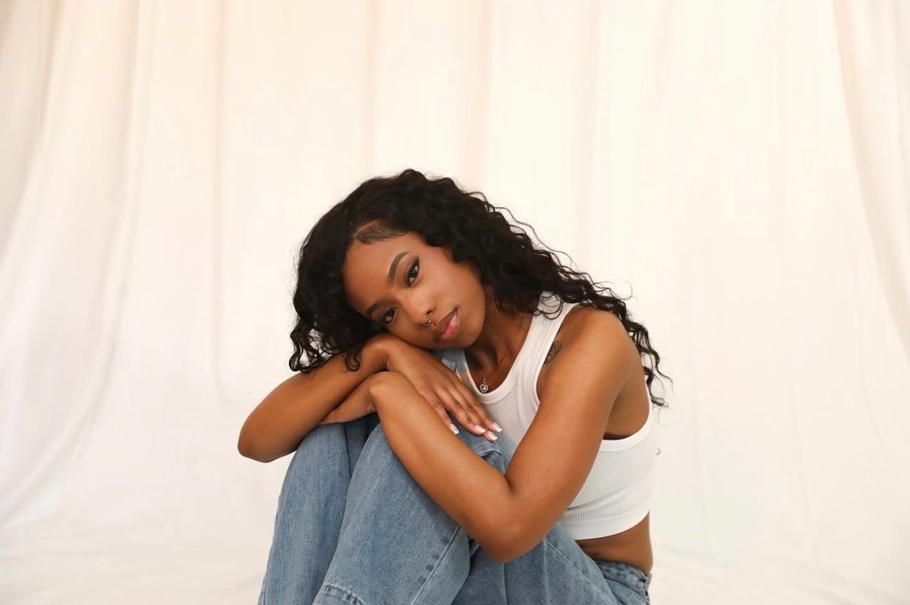 Artistic portrait with white fabric and dramatic lighting.