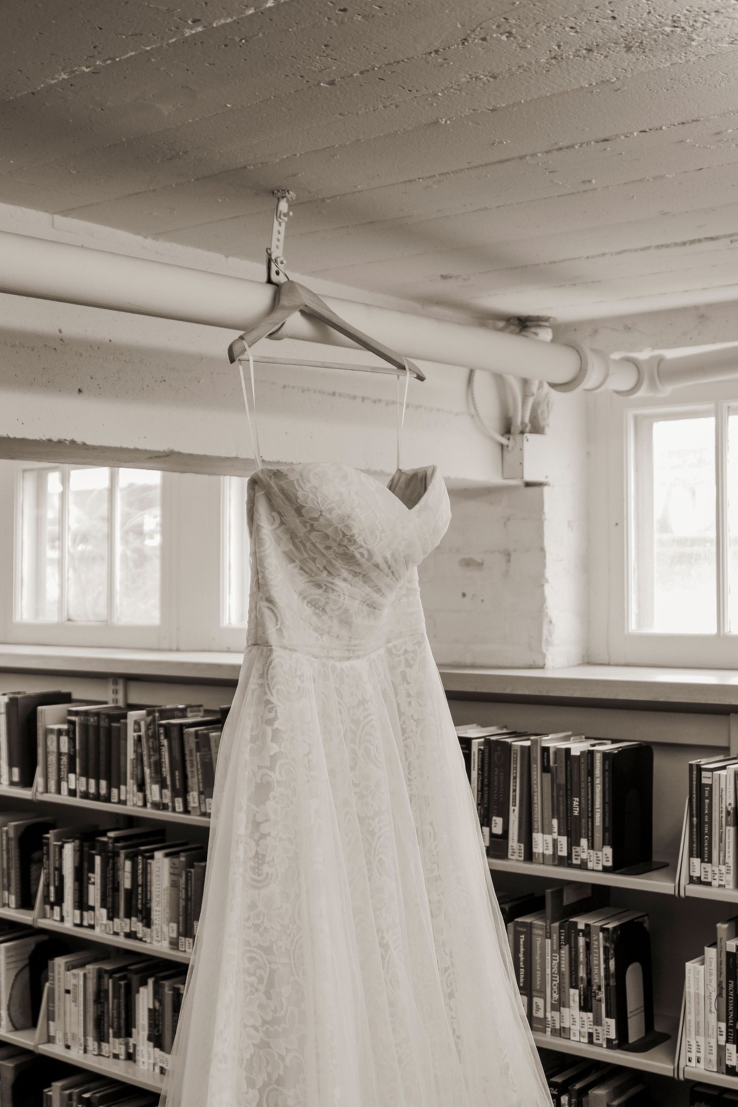 brides dress hanging in a library in Minneapolis Minnesota