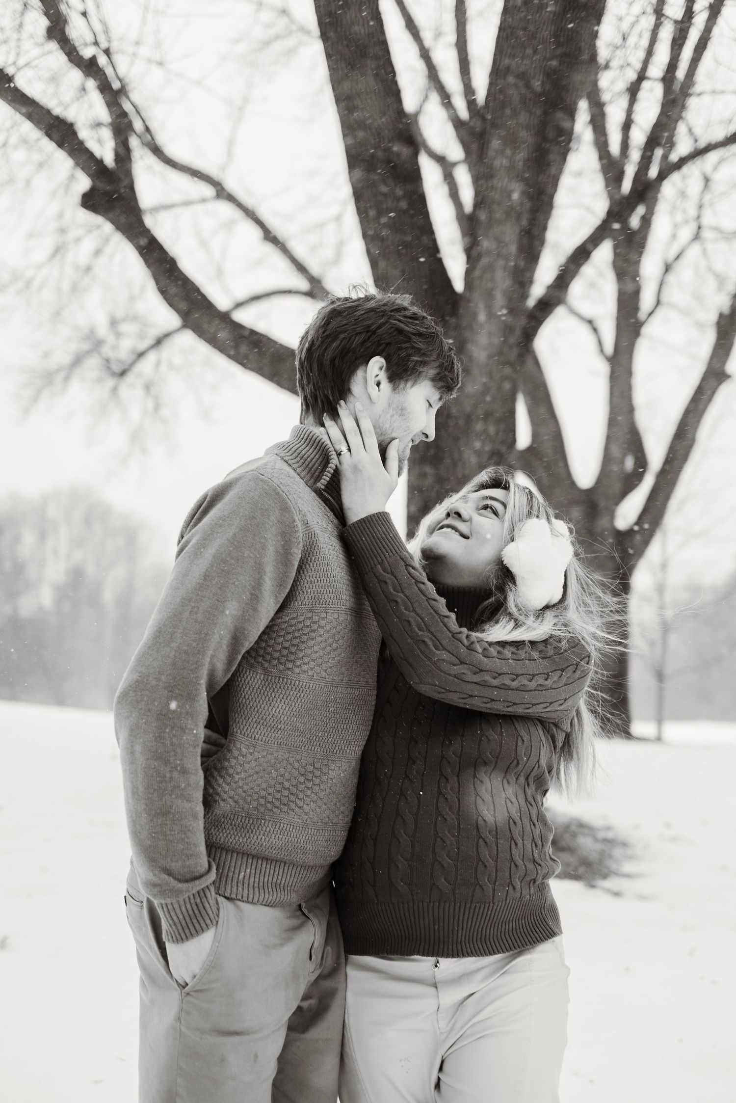 woman holding man's face in Minnesota winter