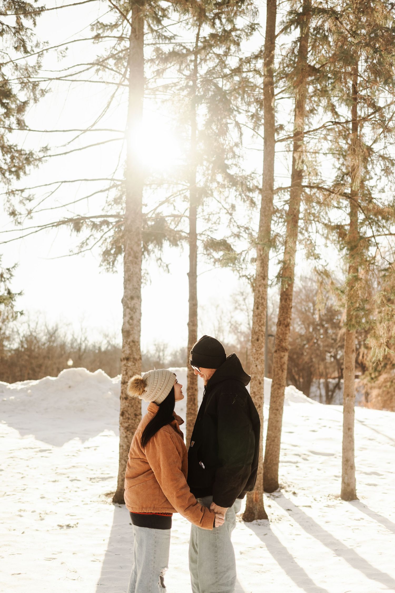 couples photoshoot by pine trees in Minnesota