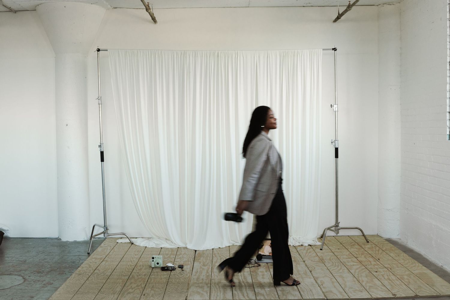 Behind-the-scenes photo shoot in minimalist white studio space.