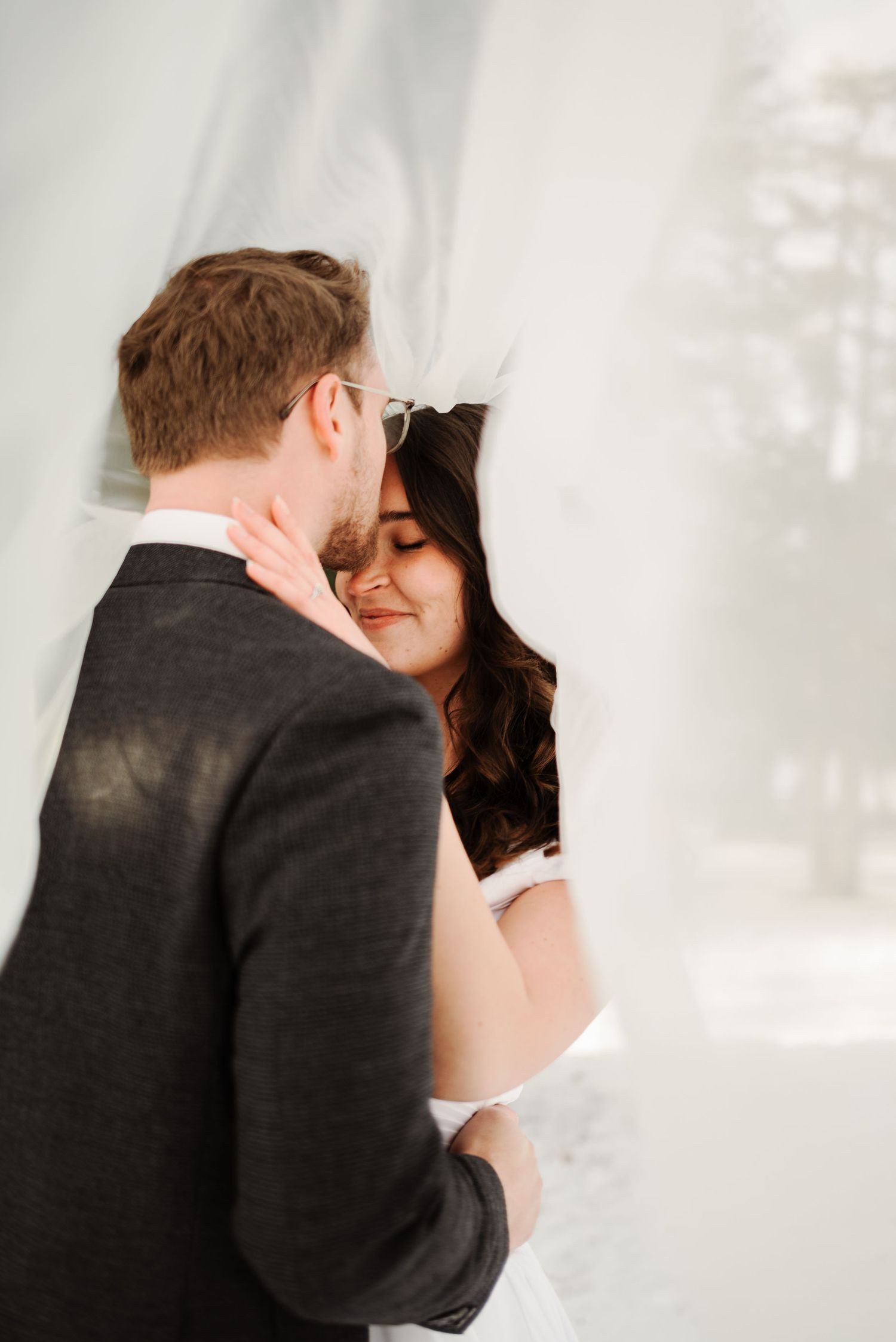 Intimate winter wedding portraits captured in soft, dreamy lighting.