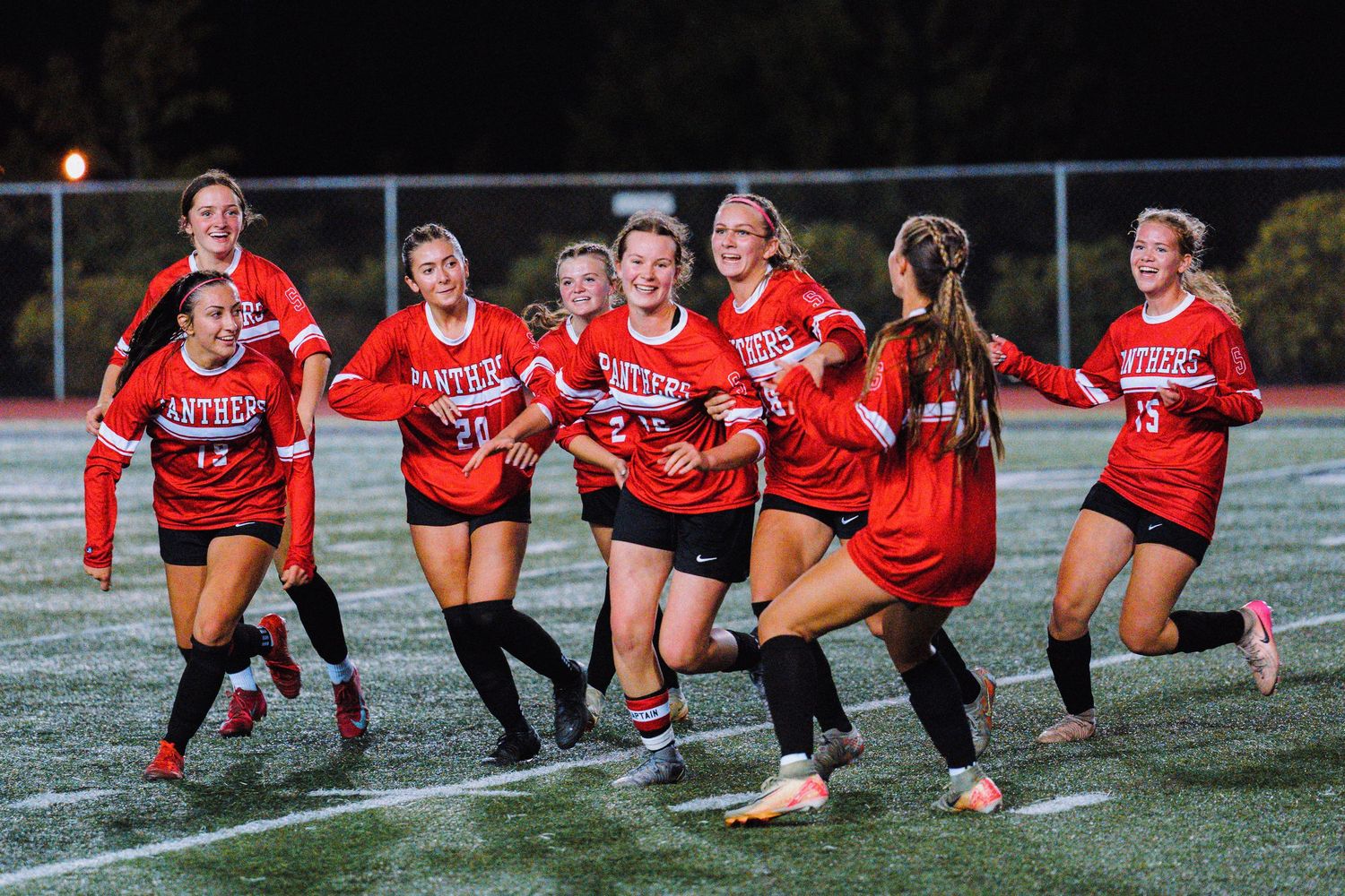 Soccer players celebrating goal