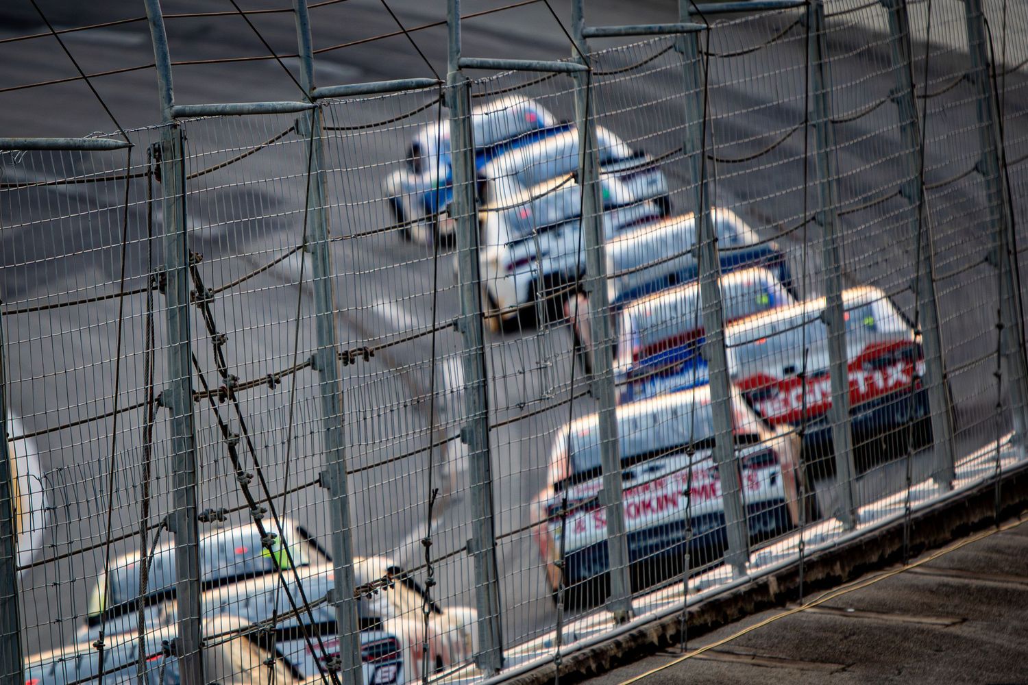 NASCAR vehicles compete on banked turn during the Bennet Transportation & Logistics 250 on February 21st 2026 at sunset