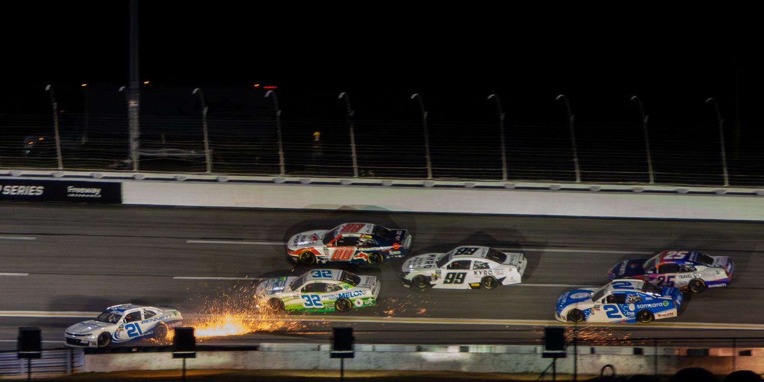 Multiple NASCAR race cars compete under the lights during the Bennet Transportation & Logistics 250 on February 21st 2026